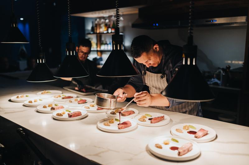 Man in kitchen preparing caribbean food