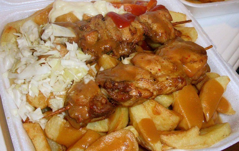 Man in kitchen preparing caribbean food